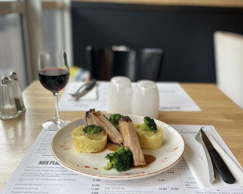 car interior from central back seat position showing driver and blurred view through windscreen of a busy road at night